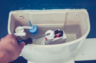 person fixing toilet float