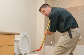 plumber with toilet auger