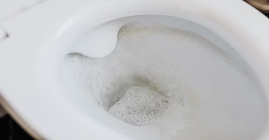 flushing water in the toilet