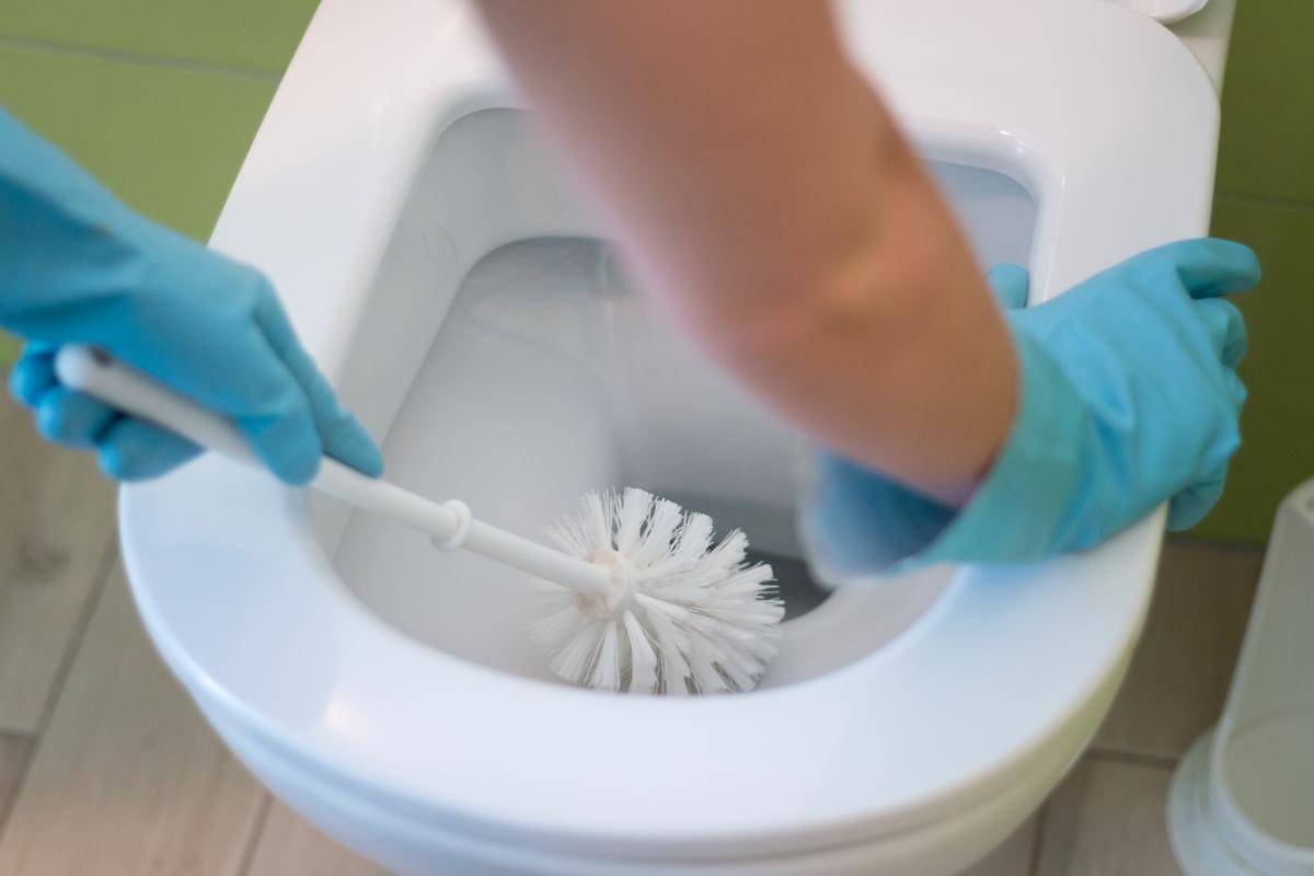 Cleaning a toilet with brush