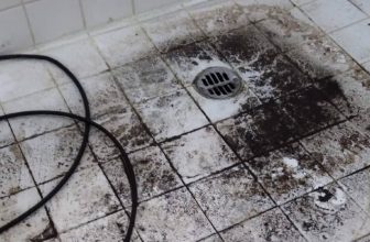 dirty floor of a clogged shower
