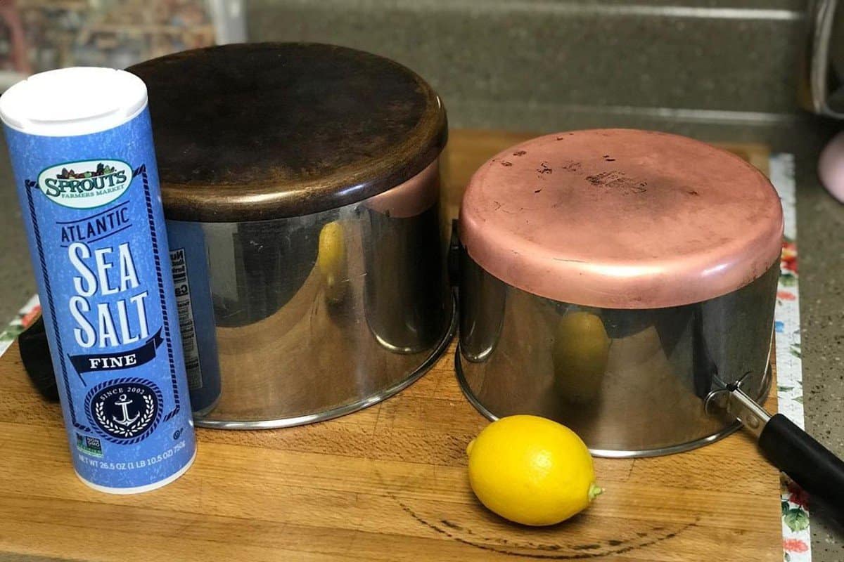 lemon and a salt can on wooden shelf